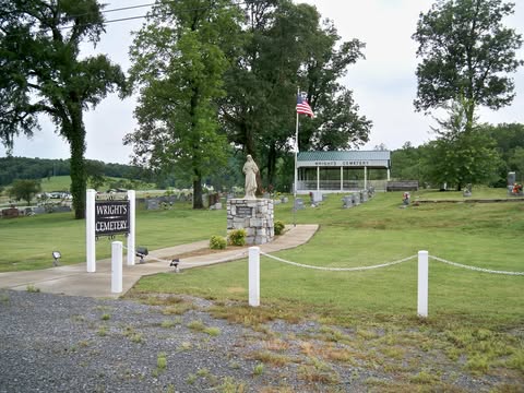 Wright's Cemetery entrance with sign and statue